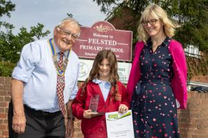 Trophy presentation to Nicole by Dunmow Rotary President Peter Watson and Felsted Primary Head Teacher Mrs Bryony Collins.